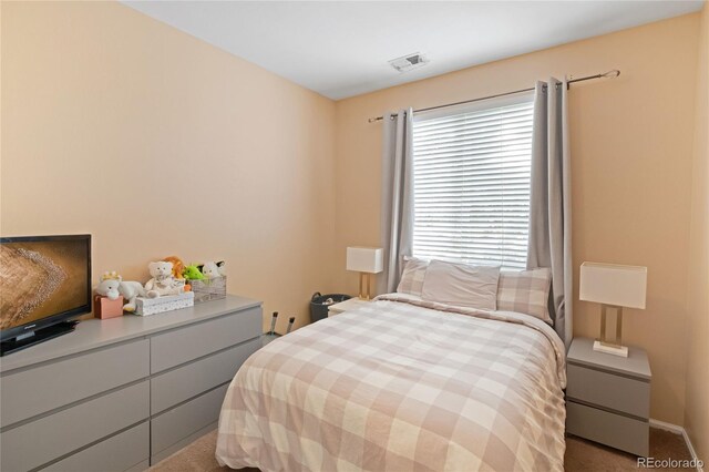 bedroom with carpet floors and multiple windows