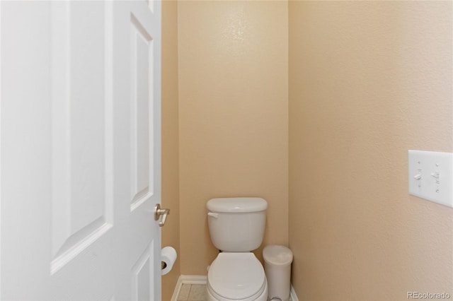 bathroom featuring toilet and tile patterned flooring