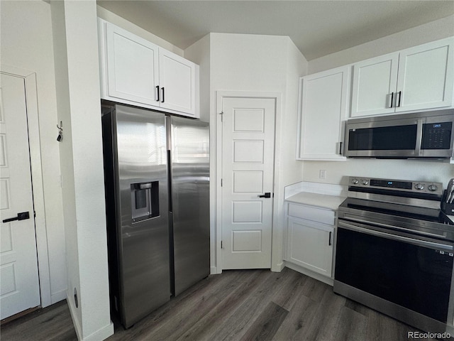 kitchen featuring white cabinetry, appliances with stainless steel finishes, and dark wood-type flooring