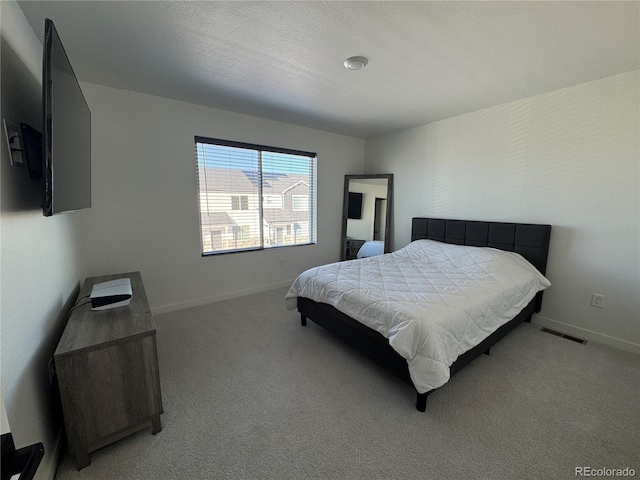 bedroom with light colored carpet