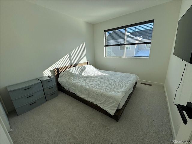 bedroom with light colored carpet