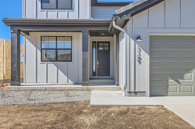 doorway to property featuring board and batten siding and a garage