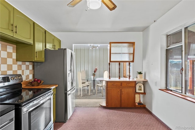 kitchen with tasteful backsplash, stainless steel appliances, carpet, green cabinets, and light countertops