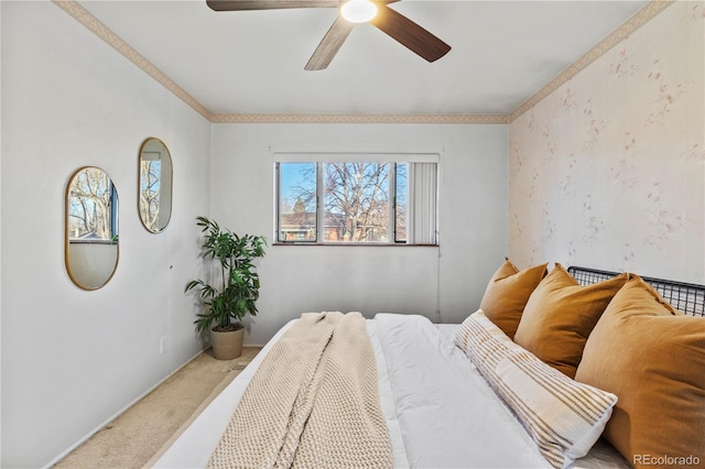 carpeted bedroom featuring crown molding and ceiling fan