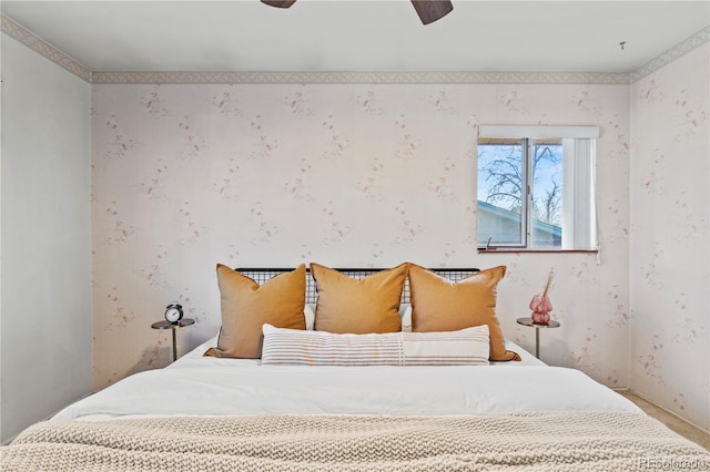 bedroom with a ceiling fan and wallpapered walls