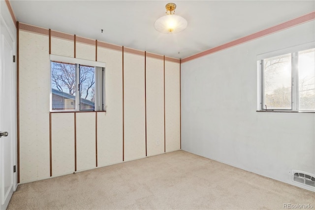 unfurnished bedroom featuring light colored carpet and visible vents