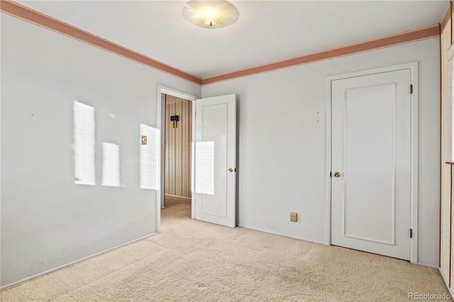 unfurnished bedroom with carpet and ornamental molding