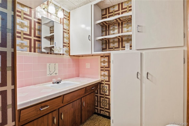 bathroom with decorative backsplash and vanity