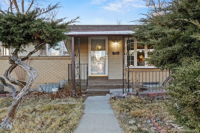 property entrance featuring brick siding