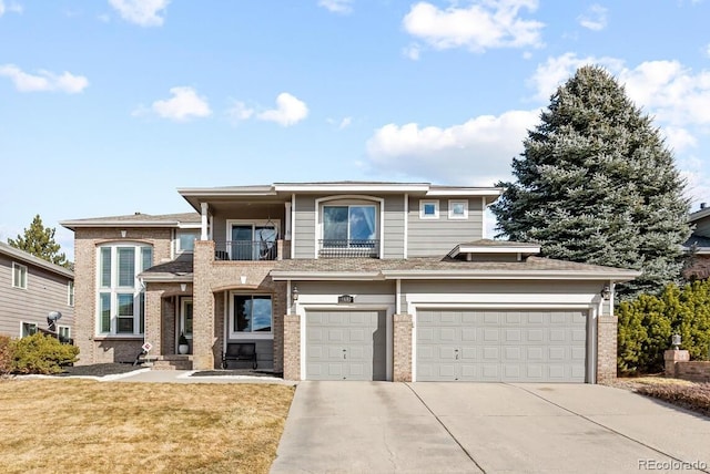 view of front of property featuring a balcony, a garage, and a front lawn