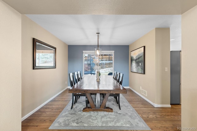 dining space with hardwood / wood-style flooring