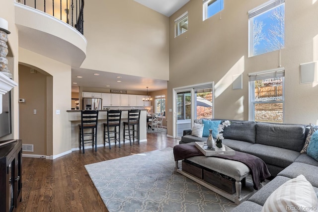 living room featuring dark wood-type flooring and a notable chandelier