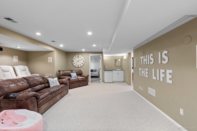 living room featuring light colored carpet and sink