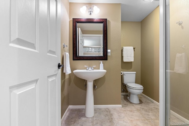 bathroom featuring tile patterned floors and toilet