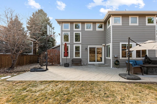 rear view of house featuring an outdoor living space, a yard, and a patio