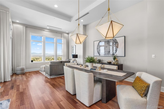 dining room featuring baseboards, recessed lighting, a towering ceiling, and wood finished floors