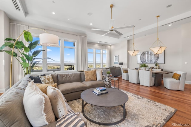 living room with ceiling fan, recessed lighting, wood finished floors, and baseboards