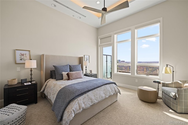 carpeted bedroom with baseboards and a ceiling fan
