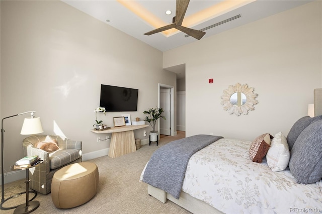 carpeted bedroom featuring a high ceiling, baseboards, visible vents, and ceiling fan