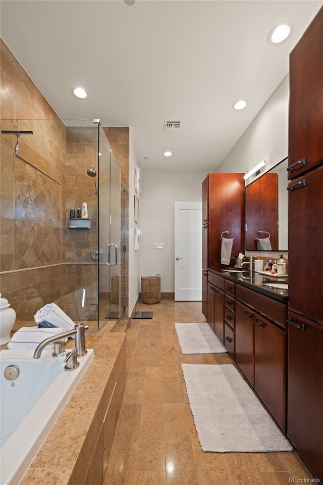 full bath featuring a bath, vanity, visible vents, recessed lighting, and a stall shower