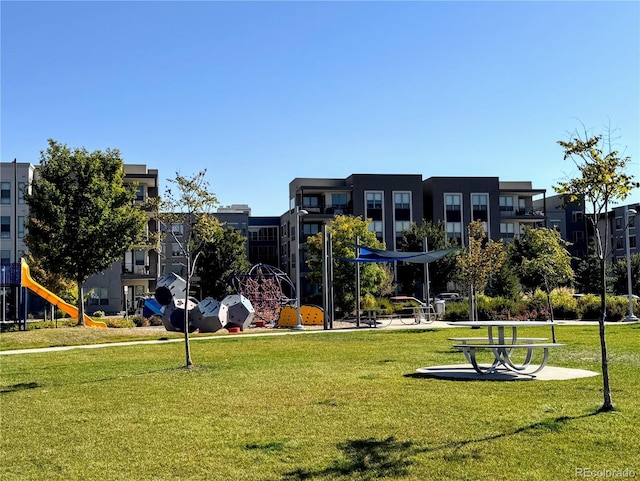 view of property's community with a lawn and a playground