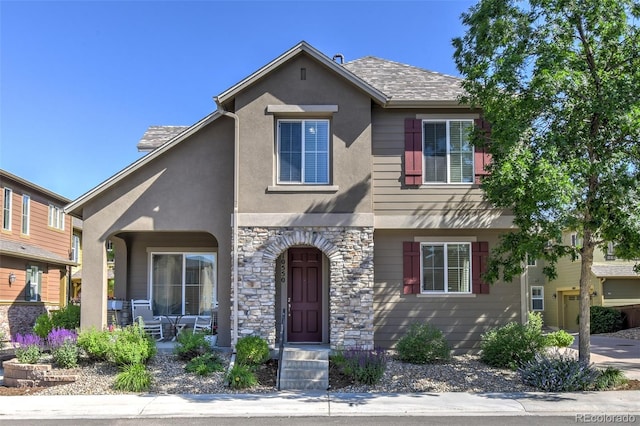 10550 Ashfield St, Highlands Ranch, CO 80126 - view of front facade featuring stone siding, stucco siding, and a porch
