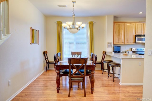 10550 Ashfield St, Highlands Ranch, CO 80126 - dining space featuring a chandelier, light wood finished floors, and recessed lighting