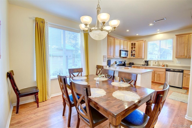 10550 Ashfield St, Highlands Ranch, CO 80126 - dining room with a chandelier, light wood finished floors, and recessed lighting
