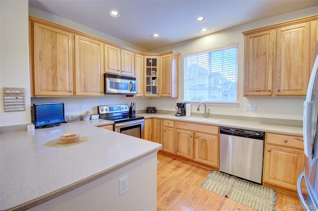 10550 Ashfield St, Highlands Ranch, CO 80126 - kitchen featuring stainless steel appliances, light brown cabinets, recessed lighting, and light countertops