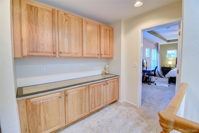10550 Ashfield St, Highlands Ranch, CO 80126 - kitchen with light brown cabinetry, light colored carpet, and recessed lighting