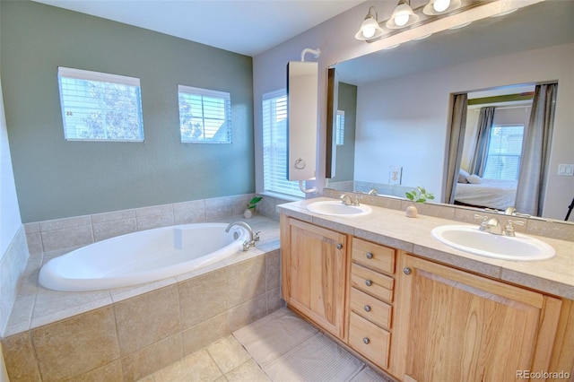 10550 Ashfield St, Highlands Ranch, CO 80126 - full bath with double vanity, a garden tub, ensuite bathroom, and tile patterned flooring