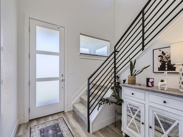 entryway featuring a wealth of natural light and light hardwood / wood-style flooring