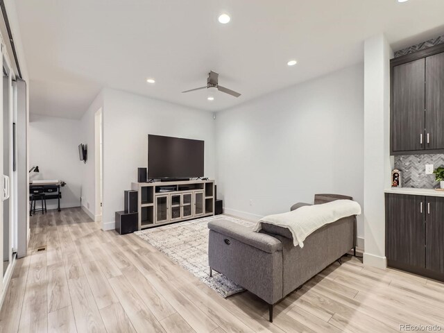 living room with ceiling fan and light hardwood / wood-style floors