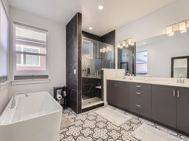 bathroom featuring shower with separate bathtub, vanity, and tile patterned floors