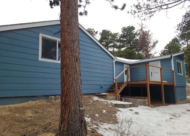 view of side of property featuring a deck