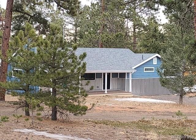 view of front of house featuring a shingled roof