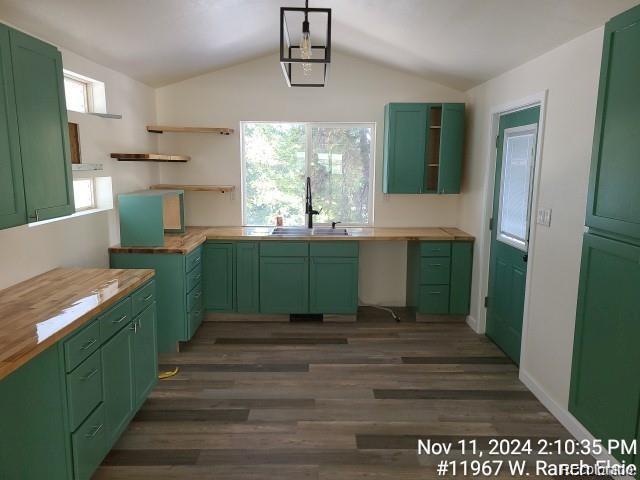 kitchen featuring green cabinets, butcher block counters, sink, and a wealth of natural light