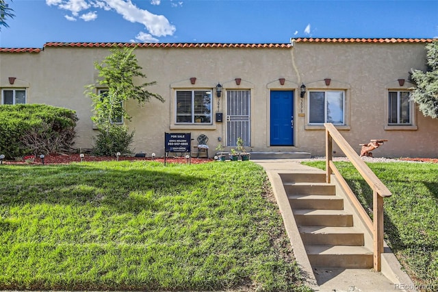 3081 W 18th Ave, Denver, CO 80204 - mediterranean / spanish house featuring a front lawn and stucco siding