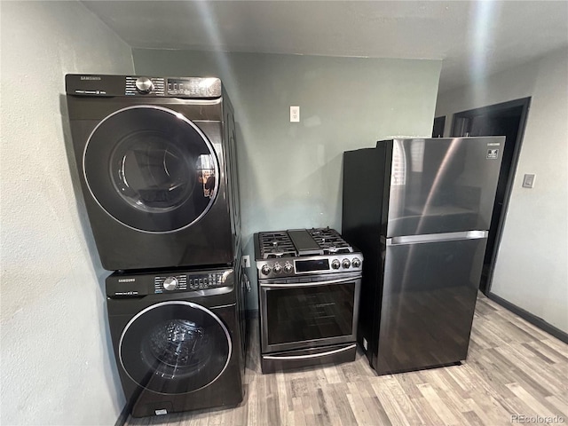 3081 W 18th Ave, Denver, CO 80204 - washroom featuring stacked washing machine and dryer and wood finished floors
