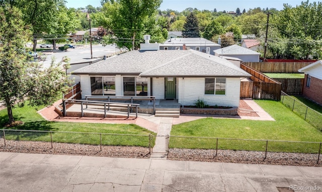 735 Valley Rd, Colorado Springs, CO 80904 - view of front facade with a shingled roof and brick siding