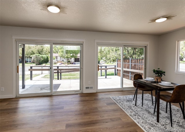 735 Valley Rd, Colorado Springs, CO 80904 - office space with dark wood-type flooring, a textured ceiling, and baseboards