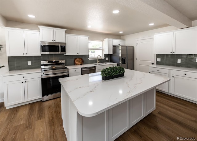 735 Valley Rd, Colorado Springs, CO 80904 - kitchen with appliances with stainless steel finishes, a sink, white cabinets, decorative backsplash, and dark wood-style flooring