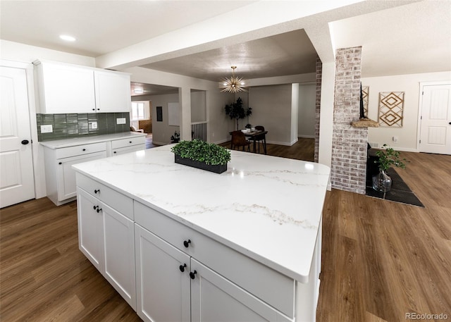 735 Valley Rd, Colorado Springs, CO 80904 - kitchen featuring wood finished floors, white cabinets, and a center island