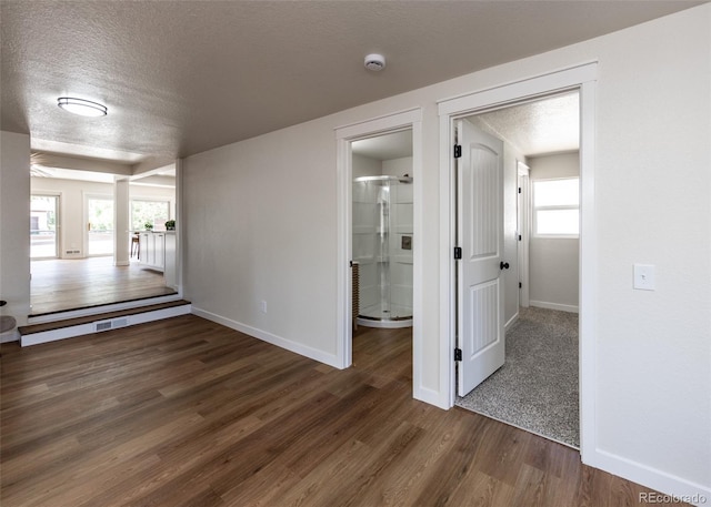 735 Valley Rd, Colorado Springs, CO 80904 - spare room featuring baseboards, a textured ceiling, wood finished floors, and a smoke detector