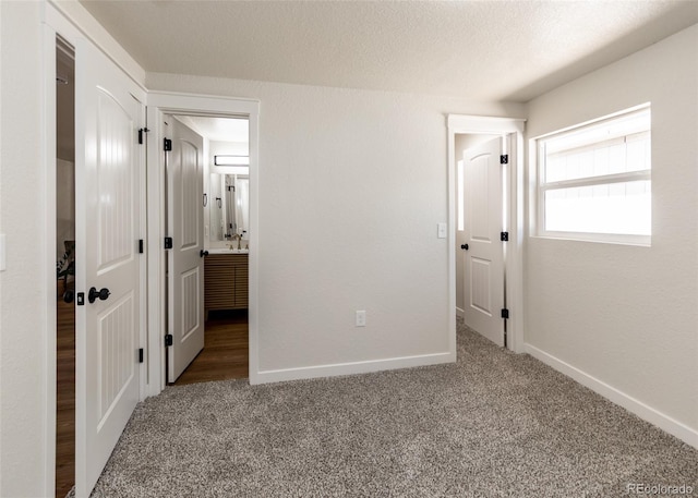 735 Valley Rd, Colorado Springs, CO 80904 - unfurnished bedroom with carpet, baseboards, and connected bathroom