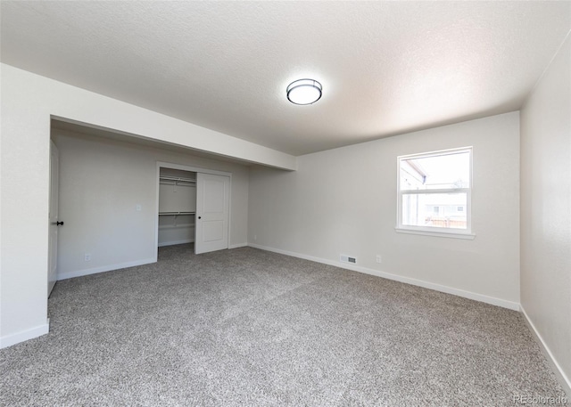 735 Valley Rd, Colorado Springs, CO 80904 - unfurnished bedroom featuring carpet, baseboards, a closet, and a textured ceiling