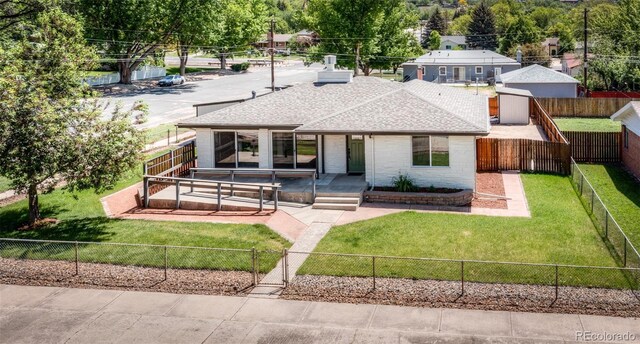 735 Valley Rd, Colorado Springs, CO 80904 - view of front facade featuring a shingled roof and brick siding