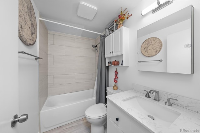 full bathroom with vanity, hardwood / wood-style floors, shower / bath combination with curtain, and toilet