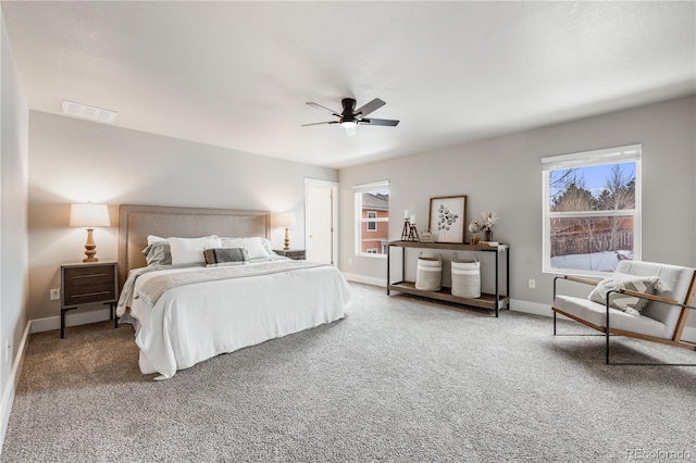 carpeted bedroom with ceiling fan, visible vents, and baseboards