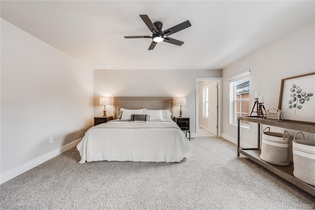 carpeted bedroom with ceiling fan and baseboards